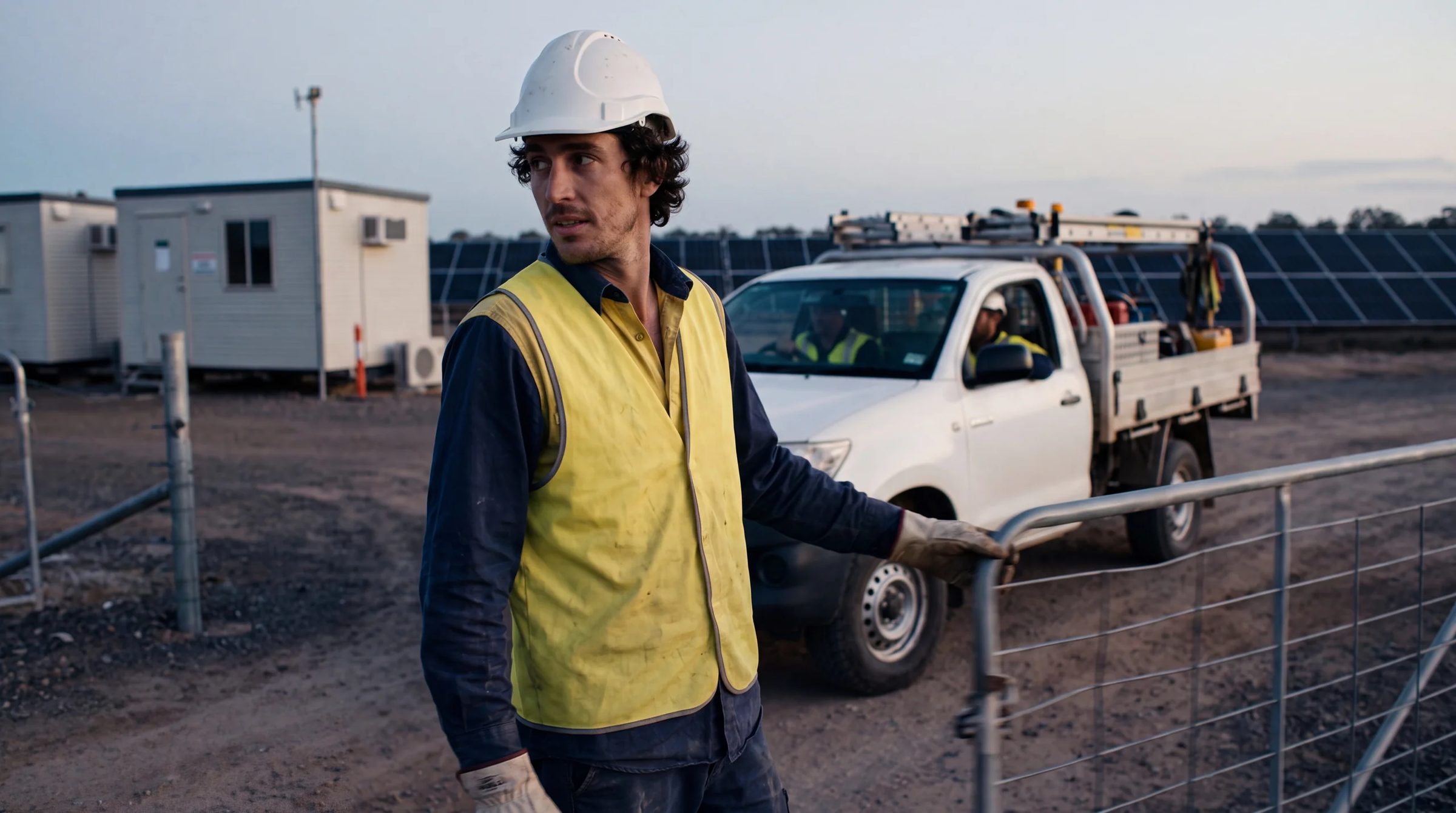Crew ute arriving at solar farm gate at dawn